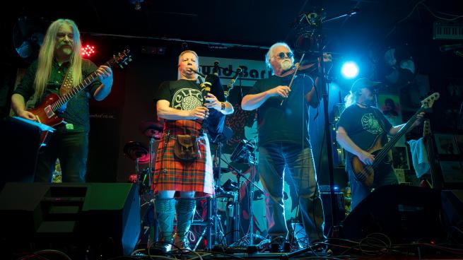 Gaelforce playing on stage.