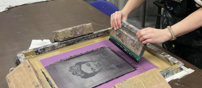 An image of Frida Kahlo being screen printed on to a t-shirt