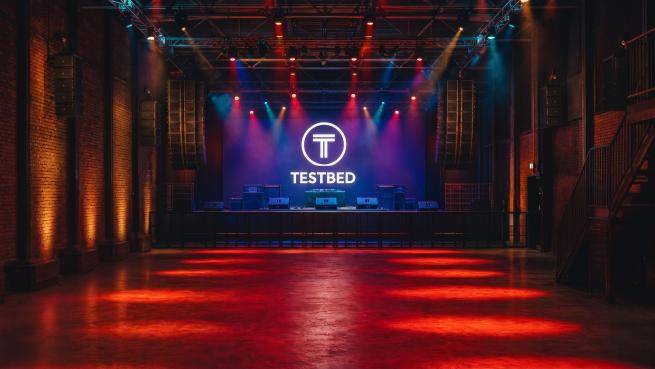 The purpose-built stage at Testbed and the brand-new mezzanine level with bar, seating and lockers for improved customer experience