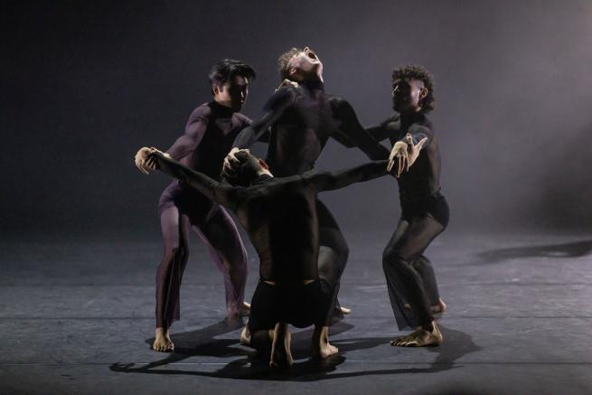 4 dancers on stage in a circle