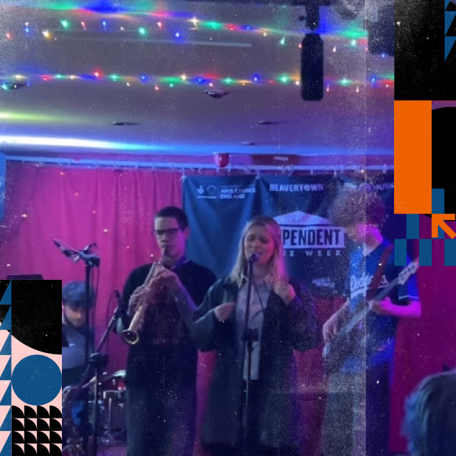 A band of 4 people playing on stage.