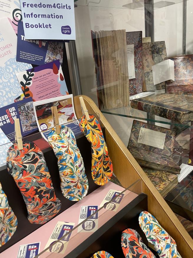 Display of multicoloured reuseable period pads with information leaflets based on Freedom4girls. 