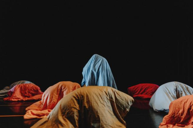 A black dance floor with sleeping bags mountains 