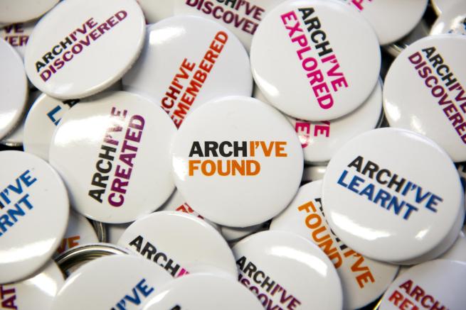 Assorted pin badges that say "Archive" on.