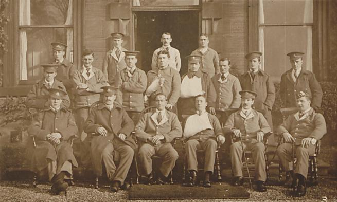 A group of soldiers posing for a group photograph. Some have visible injuries.