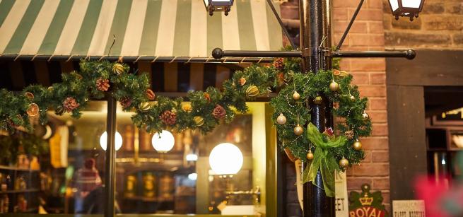 A festive wreath hanging from a lamp post in the Victorian Street at Abbey House Museum