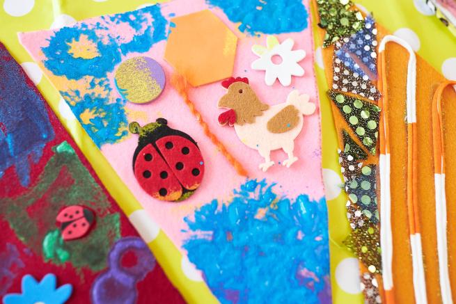 Felt collage with ladybirds and a hen