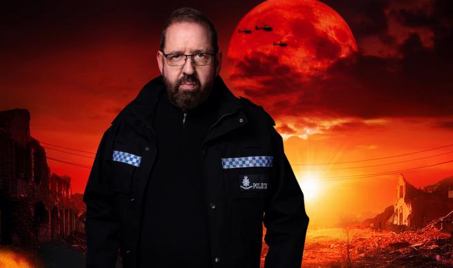 Alfie Moor in a Police coat stands in front of an apocalyptic scene an orange suns burns low in the sky highlighting a scene of ruinous destruction, helicopters fly overhead to the tune of Flight of the Valkyries