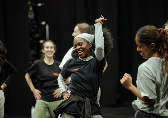 Group of people dancing in studio, smiling 