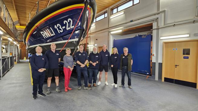 The Leeds RNLI Branch members standing in front of a large RNLI Lifeboat