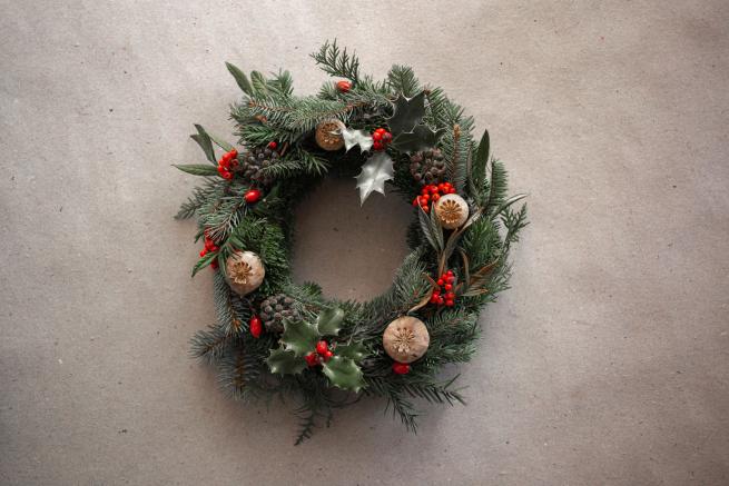A handmade Christmas wreath with holly leaves and red berries