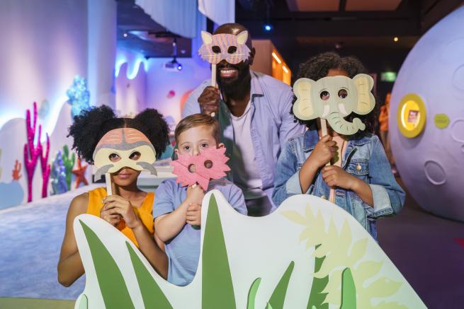 A family wearing animal masks