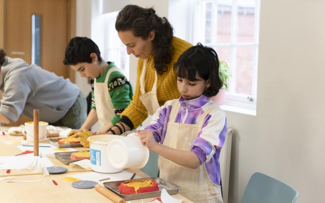 A family working together to make plaster casts of objects.