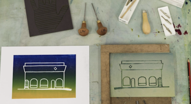 An image of a building cut into a piece of lino alongside a print in shades of blue and yellow taken from it