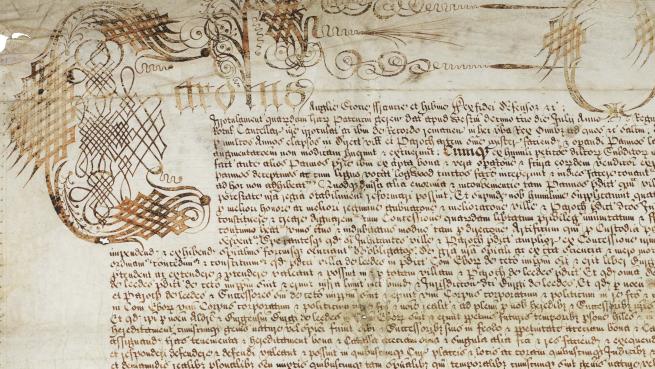 Shows Latin handwritten on a large parchment membrane, which is made from animal skin. The document shown is the Leeds Royal Charter of Incorporation, dated 1646.
