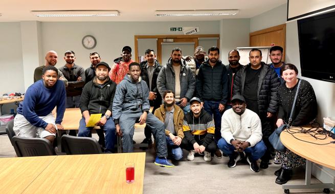 Diverse group of 18 people grouped for photo