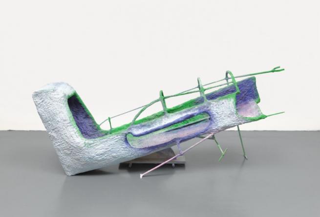 A sculpture resembling a white and green plane by Olivia Bax