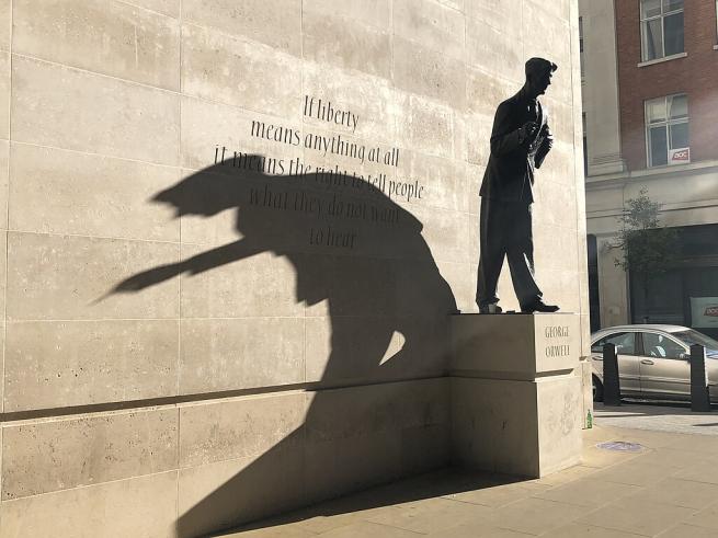 A bronze statue of George Orwell stands outside the BBC. Its long shadow falls across a stone wall engraved with the quote: 'If liberty means anything at all it means the right to tell people what they do not want to hear.