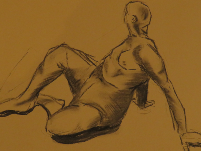Charcoal life drawing sketch on brown paper.