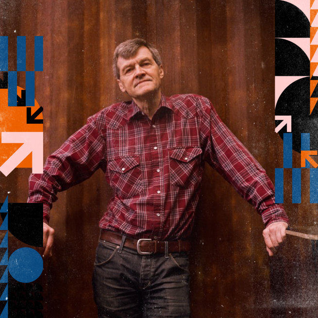 Paul Murphy standing against a wooden background