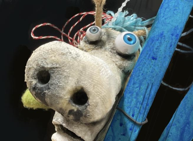 A puppet animal leans against a ladder