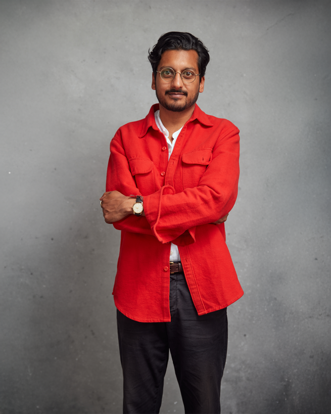 Ahir Shah in a bright red shirt