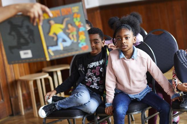 Black children listening attentively to a story