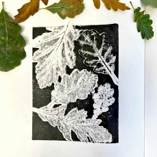a black and white mono print of fallen woodland leaves