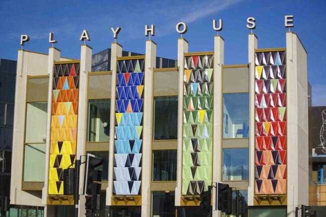 Th colourful front of the Leeds Playhouse building, with letters on top forming the word 'PLAYHOUSE'