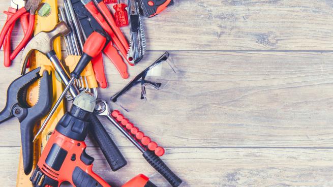 Various hand tools including hammer, drill, screwdrivers, spirit level, pliers