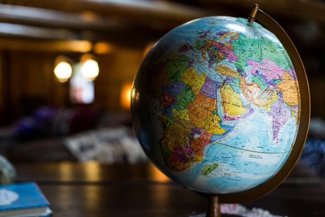 A colourful globe sits on a table.