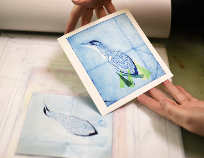 A print of a bird in shades of blue and green with the tetra pak image it was printed from