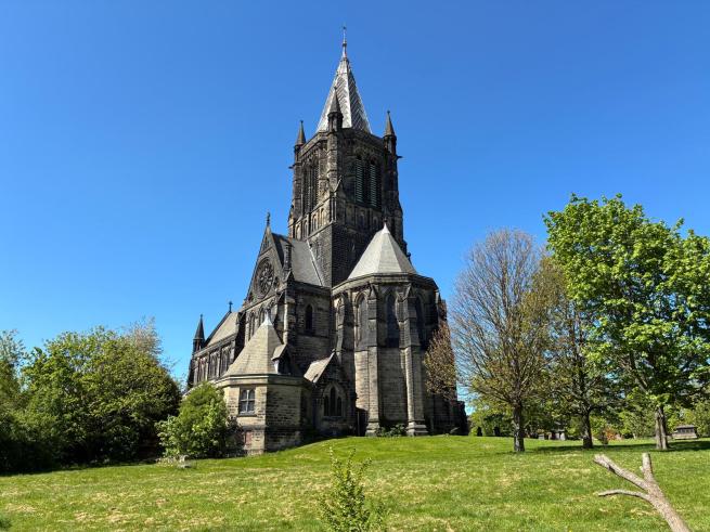A church set on a hill surrounded by green grass