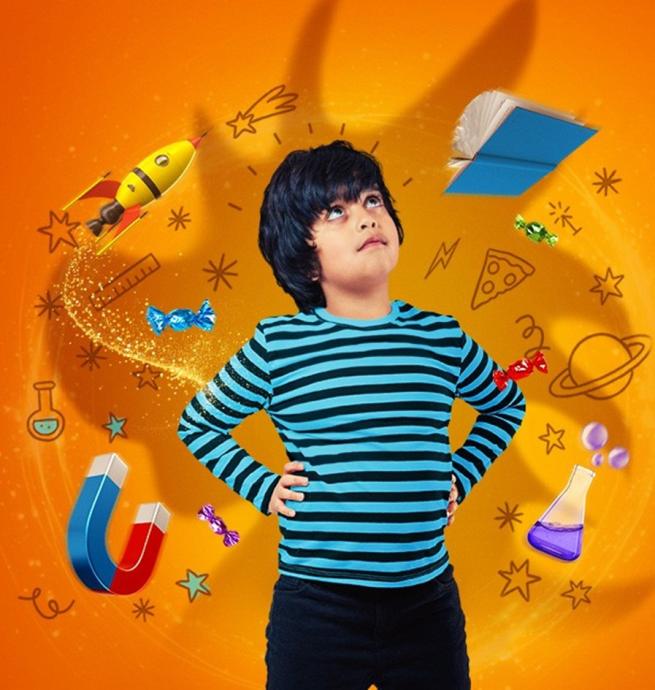 a boy in a striped top with science objects around him