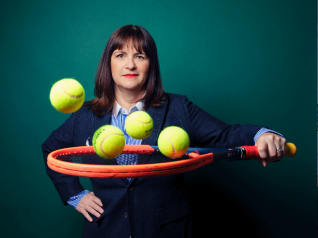 Press shot of Pauline Eyre holding a tennis racket.