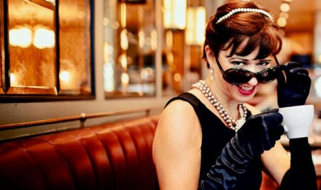 A woman dressed as Audrey Hepburn out of Breakfast at Tiffany's I think