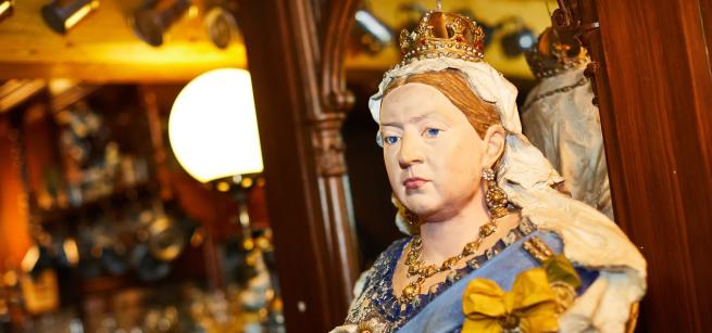 A colour photograph of a bust of Queen Victoria, sitting on the bar of the Hark To Rover pub in Abbey House Museum's Victorian Street display