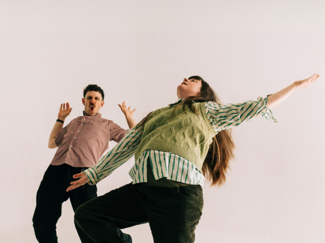 2 people dancing expressively 