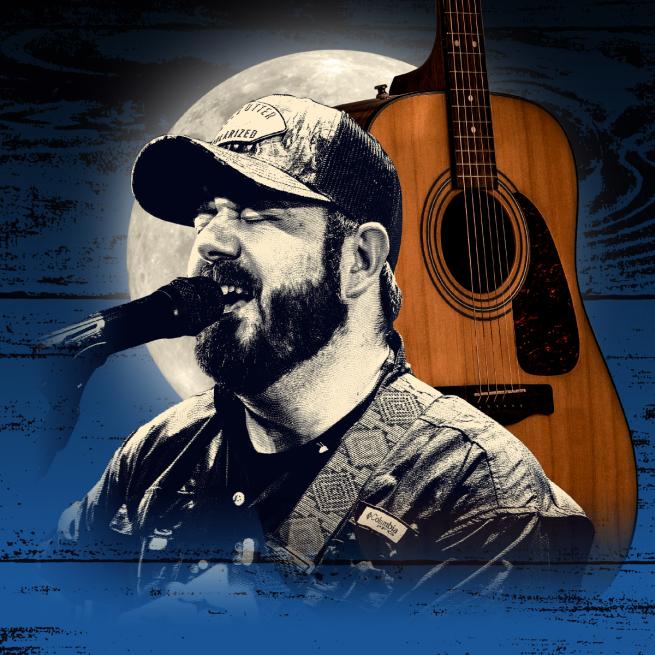 Wearing a trucker cap, Noel Boland sings into a microphone. Behind him is an acoustic guitar, a moon, and textured blue wooden panels.