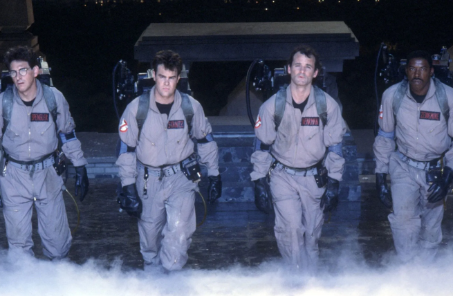 Men in matching uniforms with a machine on their backs