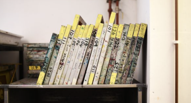 Screen printing screens stacked on a shelf