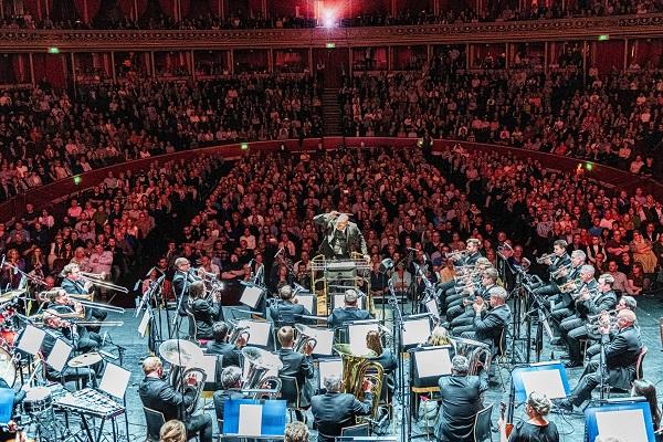 A brass band performing on a concert stage.
