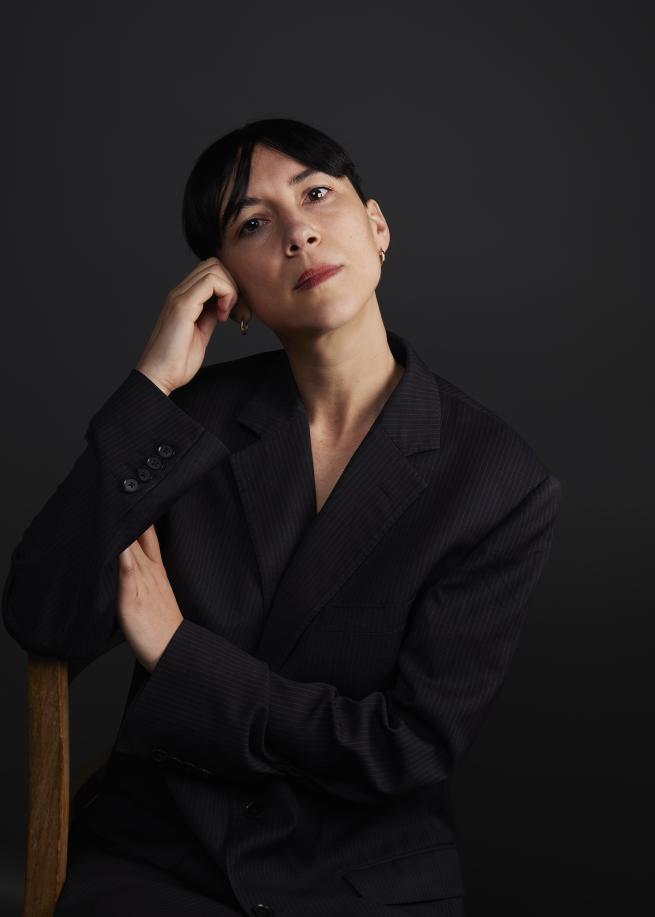 Photograph of a woman with a dark background
