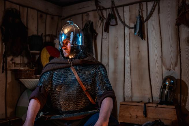 Royal Armouries actor dressed as a Saxon warrior, wearing maille and a helmet