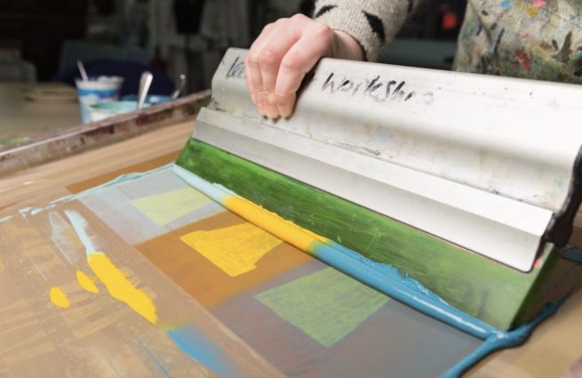 Plant pots being screen printed in blues and yellows