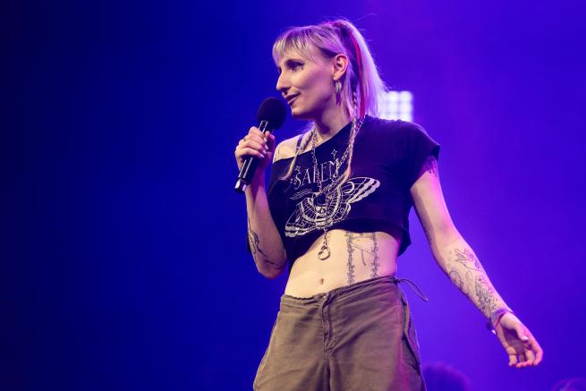 A performer on the main stage at the Roundhouse Poetry Slam Grand Final