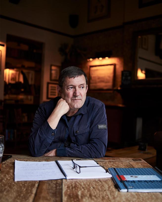 paul heaton sat at a desk