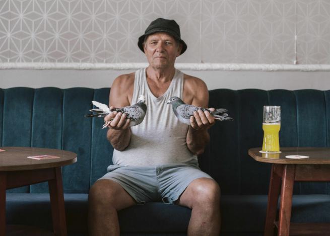 Man holding two pigeons