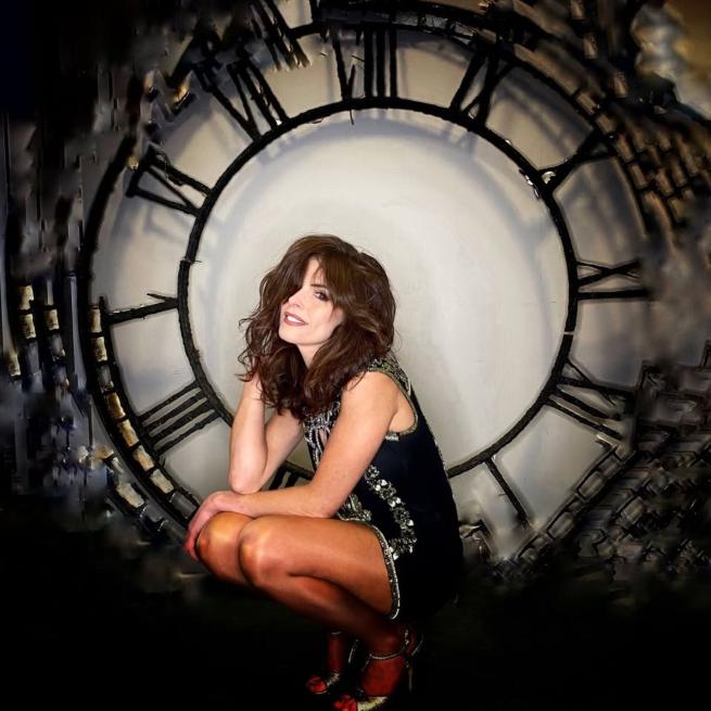 Cherie Gears in front of a clock