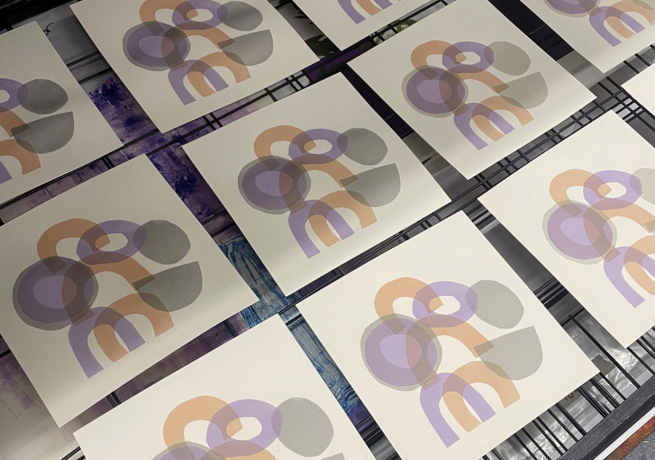 Screen printed abstract shapes on paper in muted tones of grey, lilac and orange 